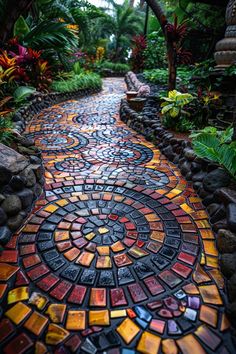 a pathway made out of colorful tiles surrounded by trees and plants in a tropical garden