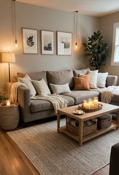 a living room filled with furniture and candles on the coffee table in front of it