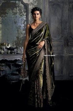 a woman in a green and gold sari