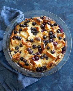 a pie with blueberries and cheese on top