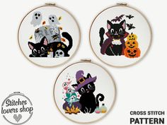 three cross stitch halloween hoops with black cats and pumpkins