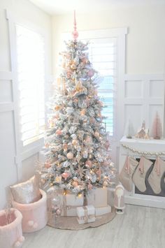 a white christmas tree with pink and gold ornaments