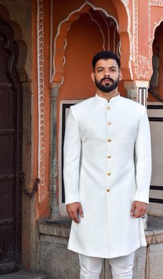 The stylish designer sherwani for men features a white cotton silk top and a white cotton churidar-style bottom, both of which are free size.  Size can be sent in cms also, For your comfort we keep a 2-inch margin so please provide the exact size without any margin The package includes: sherwani and churidar pajama.  Accessories such as mojris(shoes), stoles, turbans, and others are not included but can be ordered as extra as per your choice. Wedding Jodhpuri Suits Men, White Sherwani For Men Wedding, Traditional White Bandhgala For Festive Occasions, White Traditional Festive Bandhgala, White Nehru Jacket With Traditional Drape For Ceremonial Use, White Nehru Jacket With Traditional Drape For Ceremonial Occasions, Elegant White Traditional Wear For Ceremonial Occasions, Elegant White Ceremonial Traditional Wear, Nehru Jacket With Naqshi For Traditional Ceremonies And Festivals