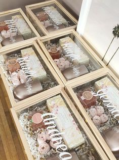 four wooden boxes filled with different types of cakes