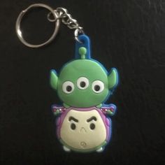 a close up of a keychain with a cartoon character on it's face