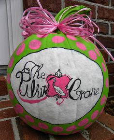 a green and pink polka dot pumpkin with the word be who's crone on it