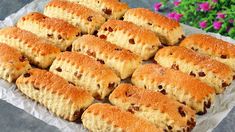 a bunch of biscuits sitting on top of a piece of paper next to some flowers