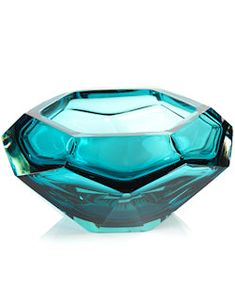 a blue glass bowl sitting on top of a white table