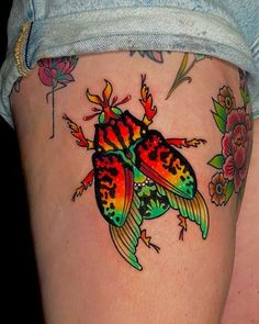 a colorful tattoo on the thigh of a woman