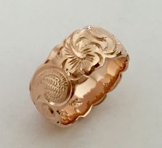 14K Gold Traditional Hawaiian Ring (8mm Barrel)Custom order and Hand made in the Aloha StateHand engraved with Scroll design - Hawaiian Hibiscus Flower and Ocean wave.Made with 14k Rose/Pink gold. Ring width is 8mm.Ring is perfect for people with an active life style, also great gift for anniversary, wedding or any special occasion.*Free inside message engraving. To make the piece more personal, you can add a special message on the inside of the ring, bracelets or pendant. Inside inscription on Hawaiian Rings, Hawaiian Ring, Hawaiian Wedding Rings, Pink Gold Ring, Hawaiian Heirloom Jewelry, Old English Letters, Gold Band Wedding Ring, Hawaiian Hibiscus, Solid Gold Bracelet