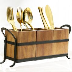 four golden forks and two knives in a wooden holder