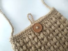 a crocheted purse with a button on it