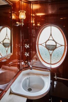 a bathroom with two round windows and a sink