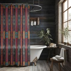 a bath tub sitting next to a window in a bathroom with wooden floors and walls