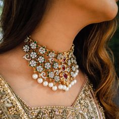 An embodiment of heritage and femininity! The look includes necklace, earrings and jhoomar. The stunning and classy set is adorned with kundan stones and glistering ruby, emerald and CZ stones, complemented with beautiful jhoomar that is delicately crafted using sparkly CZ stones and dangling beads. Approximate earrings length is 3". Gold-plated on high-quality brass as base metal. Made by order. Kindly allow 4-6 weeks for the delivery of this item. For custom or urgent requests, please contact Diamond Chandbali Kundan Necklace For Reception, Heavy Bollywood Kundan Necklace With American Diamonds, Festive Chandbali Bridal Necklace With American Diamonds, Bollywood Kundan Necklace With Intricate Design, Bollywood Style Diamond Kundan Necklace With Intricate Design, Designer Chandbali Bridal Necklace With Intricate Design, Designer Bridal Chandbali Necklace With Intricate Design, Festive Chandbali Kundan Necklace With Diamonds, Festive Diamond Kundan Chandbali Necklace