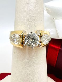 Beautiful 14K Yellow Gold Diamond 2.25ct Ring Size 5.5 A perfect gift for your loved one for any special occasion or holiday! Total Ring Weight: 7.42g Ring Length: 23.40mm Ring Width: 19.90mm Gemstone: Diamond Total Diamond: 2.25ct Center Diamond approximately 1.25ct Side Diamonds approximately 1.00ct Item will be placed into a gift box. * Gia Certified Trillion Cut Diamond Ring, Vvs Clarity Pear-shaped Diamond Ring For Anniversary, Gia Certified Heart Cut Diamond Ring For Formal Occasions, Gia Certified Heart Cut Diamond Anniversary Ring, Gia Certified Pear-shaped Ring For Anniversary, Gia Certified Pear-shaped Anniversary Rings, Pear-shaped Gia Certified Rings For Anniversary, Gia Certified Heart Cut Rings For Anniversary, Classic Anniversary Diamond Ring With Trillion Cut