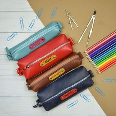 This stylish leather pencil case from is a must-have for any stationery junkie. It's more than just a place to store your favorite writing utensils, it's an expression of your personality. Our pen carrying case is the perfect solution to organizing your desk, or being able to find a pen in a pinch without having to dig through your bag or purse. Suitable for men and women. TAB PLACEMENT & COLOR A tab (tag, badge) is riveted onto pencil case. If you don't enter a color of the tab, it is made Leather Zipper Pouch, Leather Pencil Case, Writing Utensils, Wooden Pen, Pencil Pouch, Id Holder, Leather Zipper, Personalized Leather, Student Gifts