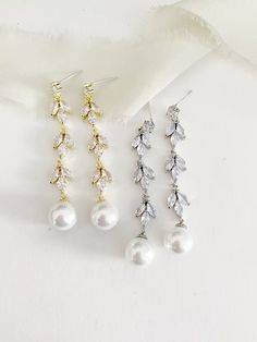 These stunning earrings will add the perfect touch of sparkle and elegance to your wedding or special event outfit! Made with high quality materials, these CZ earrings will be sure to impress in person and in photographs.... i n f o  +  d e t a i l s ...Made of AAA quality Cubic Zirconia stonesFaux pearl stonesPush on backings included6cm long by 1cm wideLead, Nickle, and Cadmium free*Due to hygienic reasons, no returns or exchanges permitted on hair accessories or earrings*..................... Bride Drop Earrings, Mother Of The Bride Earrings, Statement Bridal Earrings, Bridal Party Earrings, Bridal Statement Earrings, Formal Earrings, Sparkly Wedding, Bridal Earrings Drop, Wedding Earrings Drop