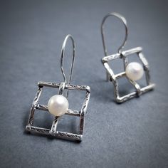 Bridal Pearl Earrings 925. Very elegant geometric earrings made out of Silver 925 and natural freshwater Pearl. You can choose between two different sizes.  If you want to make them a set, here is the matching pendant: https://www.etsy.com/listing/258712074/silver-handmade-pendant-with-pearl?ga_search_query=pendant%2Bsquare&ref=shop_items_search_2&frs=1 Details: Material: Sterling Silver 925 and Pearls 5 mm diameter (0.2 inch) Width: 16mm (5/8 inch) Length: Choose between two options A 35mm (1 3 Modern Pearl Earrings For Gift, Modern Drop Pearl Earrings As Gift, Modern White Gold Pearl Earrings Gift, Modern White Gold Pearl Earrings For Gift, Modern Pearl Earrings With Ear Wire As Gift, Sterling Silver Pearl Earrings Gift, Gift Pearl Earrings In Sterling Silver, Modern Sterling Silver Pearl Earrings For Gift, Modern Sterling Silver Pearl Earrings As Gift