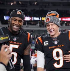 two football players standing next to each other