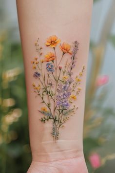 a woman's arm with flowers painted on it