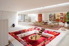 a living room filled with lots of furniture and bookshelves on top of each other