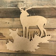 a wooden cutout of two deer standing next to each other