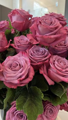 a vase filled with pink roses on top of a table