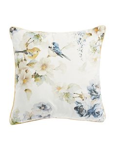 a white pillow with blue and yellow flowers on it