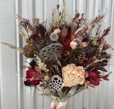 a vase filled with lots of different types of flowers