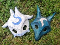 two masks are laying on the grass