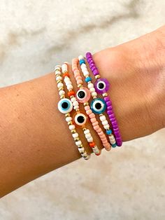 1 bracelet. Customizable evil eye bracelet. Please use customization notes to specify any additional color beads, as well as preferred pattern. Gelang Manik, Bracelets Diy, Wrist Wear, Color Beads, Beautiful Mask, Beaded Bracelets Diy, Eye Bracelet, Beaded Accessories, Evil Eye Bracelet