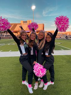 the cheerleaders are posing for a photo on the football field with their pom poms