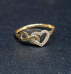 "10k Real Solid Yellow Gold Infinity Heart Ring, 10k Solid Gold Women Heart Ring, Infinity Symbol Gemstone Gold Ring for Women, Gift,  Gold Ring, Minimalist Ring * Metal : Real 10K Yellow Gold, (Properly Stamped, 10K)  * Condition : Brand New * Finish : Polished * Band thickness: 1.5 mm  * infinity Size: 11 mm length, 5mm width * Heart Size: 8 mm length, 12mm width * Scale: : 6,5US, 7US, 7.5US,8US, 8.5US * Stone: Cubic Zirconia These Rings are 100% Authentic 10K Solid Real Gold .  \"Not Plated or Filled\" This is a Beautiful Genuine Real 10K Solid Gold  Infinity Ring BOSPHORUSGOLD" Low Weight Gold Rings, Infinity Heart Ring, Infinity Gold Rings For Women, Infinity Ring Design For Women, Real Gold Ring, Latest Ring Designs Gold For Women, Gold Ring Design For Women Latest Gold Ring Design For Women, Ring Designs Gold For Women, Gold Finger Rings For Women