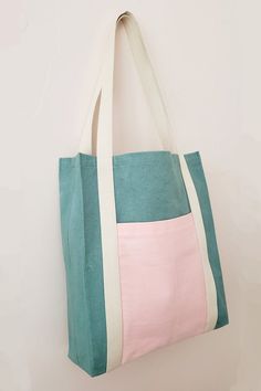 a green and pink bag hanging on the wall