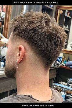 A stylish Mohawk fade haircut for men, featuring a textured top with faded sides. This trendy haircut combines the boldness of a Mohawk with the clean look of a fade, creating a modern and edgy appearance. Perfect for those looking to stand out with a distinctive hairstyle. #MohawkFade #FadeHaircut #MensHairstyles #TrendyHaircuts #ModernMohawk Birds Fade Haircut, Mens Hairstyles Mohawk Fade, High Fade Faux Hawk, Fading Haircut Men, Skin Fade Mohawk, Eurohawk Mens Haircut, Low Fade Mohawk Men, Mens Mohawk Fade, Short Mohawk Men