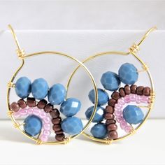 This Beautiful hoop earrings made with golden wire wrapped, blue navy crystals and seed beads ( brown/pink) . Fantastic lightweight earrings, a great accessory for any occasion. hey are charming earrings, you can wear them on any occasion, they do not weigh and are easy to put on. I can also make a similar piece in a different color if requested. If you have any questions about this item, please feel free to contact me. I would love to hear from you! MATERIALS We use good quality materials such Faceted Beads Round Beaded Earrings As Gift, Faceted Beaded Earrings For Gift, Round Faceted Beaded Earrings For Gifts, Gift Round Faceted Beaded Earrings, Gold Wire Wrapped Earrings, Blue Hoop Earrings, Dangle Beaded Earrings, Earrings With Crystals, Wrapped Earrings