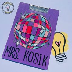 a clipboard with the words mrs koskik on it and a light bulb