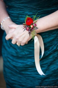 a close up of a person wearing a dress and holding a flower in their hand