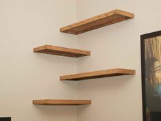 three wooden shelves mounted to the wall