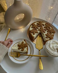 a white plate topped with two slices of cake next to cupcakes and a fork