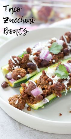 two stuffed zucchini boats on a white plate