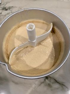 a food processor filled with batter on top of a counter