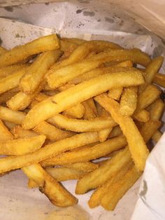 french fries are in a basket on the table