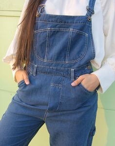 Vintage long dungarees in dark blue denim. Single front pocket. Front and back pockets. Size medium, UK 10-14 / EUR 38-42. Measurements - 9"(23cm) top of bib - 13"(33cm) bottom of bib - 32"(82cm) waist - 40"(102cm) hips - 27"(69cm) inner leg - 13.5"(35cm) rise. Material - Cotton & Modal mix. Condition - Excellent. Handpicked, repaired and ready to wear. This is an original vintage item, not new and minor signs of wear & age are expected, we will highlight any major flaws. Model is a UK 6/8 and is 5'7" tall. Womens Overalls, Dark Blue Denim, Overalls Women, Dungarees, Front Pocket, Blue Denim, Dark Blue, Overalls, Ready To Wear