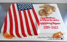 the cake is decorated with an american flag and marine seal on it's side