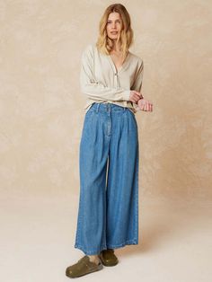 These wide leg jeans from indi & cold are cut from 100% lyocell with a denim wash. soft and fluid they feature a double pleat at the front french cut pockets at the front and two patch pockets at the back. designed for a slightly loose fit.    - 100% lyocell with denim wash  - relaxed fit  - double dart on the front to give width  - french cut pockets on the front  - patch pockets on the back  - button closure  - flat measures on size 36: rise length 31cm. inseam length: 62cm  - sizing: +1cm length per size and +2cm in chest/waist measurements  - made in portugal  - wash at low temperature  - do not tumble dry Medium Wash Tencel Wide Leg Bottoms, Wide Leg Tencel Bottoms In Medium Wash, Light Wash Tencel Straight Leg Bottoms, Relaxed Fit Light Wash Wide Leg Pants For Fall, Fall Light Wash Relaxed Fit Wide Leg Pants, Versatile Relaxed Fit Wide-leg Jeans, Fall Relaxed Fit Light Wash Wide Leg Pants, Relaxed Fit Wide-leg Versatile Jeans, Versatile Wide-leg Relaxed Fit Jeans