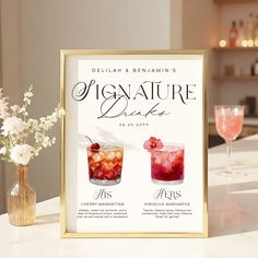 there is a sign that says signature drinkers on the counter next to a vase with flowers in it