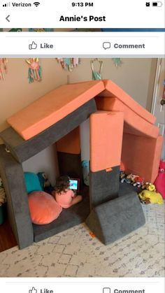 a kid laying in a bed made to look like a house