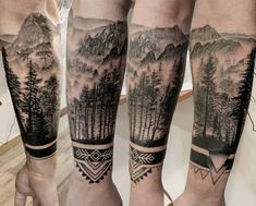 two men's legs with tattoos on them and trees in the mountains behind them